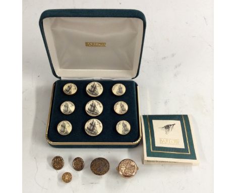 A set of nine graduated circular scrimshaw type buttons, engraved with scenes of sailing ships, made by Barlow Designs , boxe