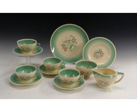 A Susie Cooper Dresden Spray part tea service, comprising four cups and saucers, sugar bowl, cream jug, dinner plate and side