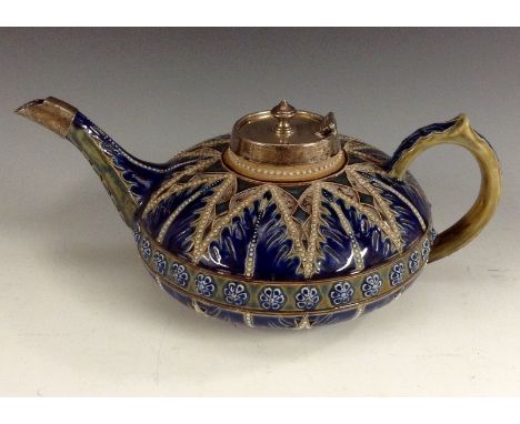 A Royal Doulton Lambeth compressed teapot, decorated in relief with blue and and green tones, beaded borders, silver mounts, 