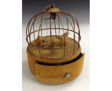 An early 20th century automaton as singing birds in a cage, in working order when the drawer is pulled out, the base encircle