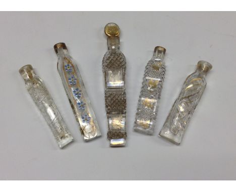 A George III Oxford teardrop lavender glass scent bottle, decorated with enamel and gilt, 9cm long, c.1830;  another attar th