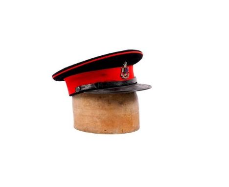 A scarce officer's peaked SD cap of the Cinque Ports Regiment, blue cloth with red band and piping, fine enamelled and silver