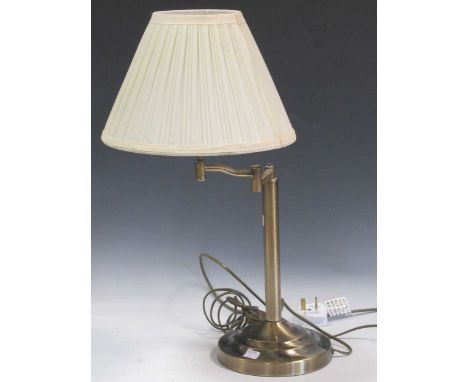 A modern brass adjustable table lamp, with shade