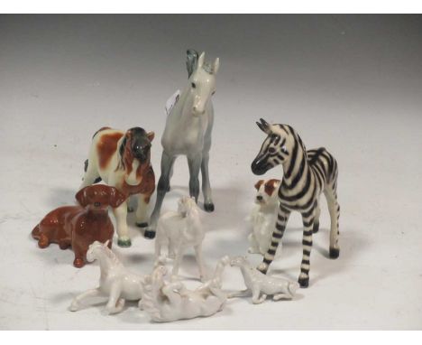 A collection of ceramic animals to include a Beswick dachshund, a Western Germany zebra and pony, a Royal Doulton standing te