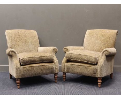 A pair of armchairs upholstered in animal print material