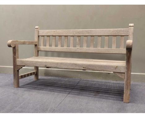 A 20th century teak garden bench 90 x 154 x 68cm and two similar teak garden armchairs (3)Provenance: Landwade Hall, Exning, 