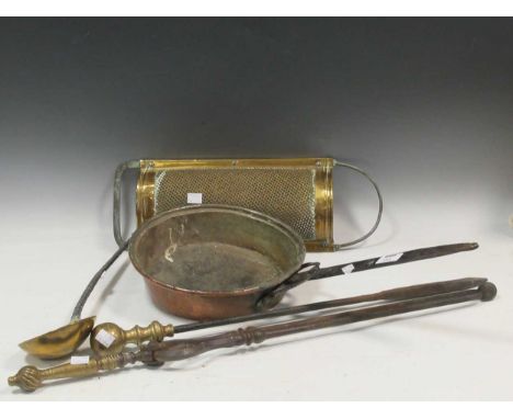 A copper pan, a brass grate and ladle, fire poker and prongs Provenance: The studio of Michael Stennett