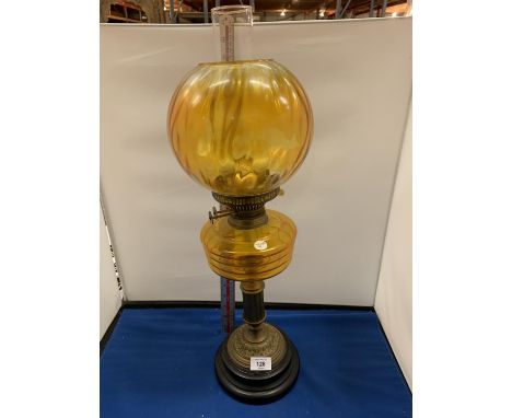 AN AMBER GLASS OIL LAMP 