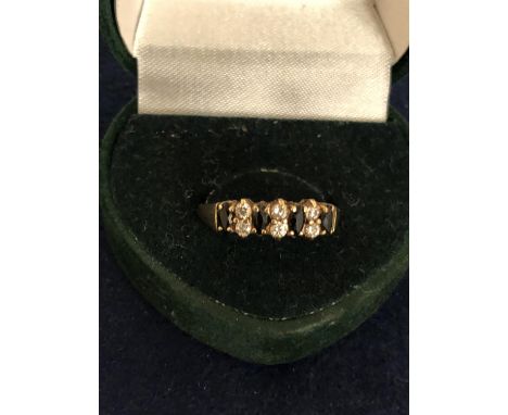 9CT MARKED BLUE AND WHITE CZ SET HALF ETRNITY RING SIZE N.5. TOTAL GROSS WEIGHT APPROX 2 GRAMS 