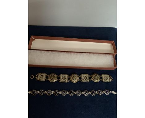 WHITE METAL TURKISH EYE BEAD BRACELET AND A VINTAGE BRASS AND ENAMEL CELTIC STYLE COSTUME BRACELET 