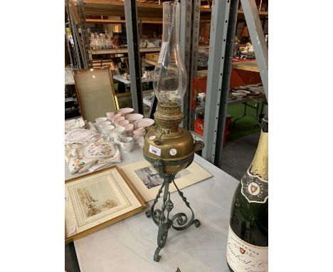 AN ARTS AND CRAFTS BRASS AND METAL OIL LAMP 