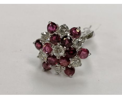 AN 18CT WHITE GOLD DIAMOND AND RUBY CLUSTER RING, TOTAL DIAMOND WEIGHT 1.45 CARATS, WEIGHT 5.6 GRAMS, INSURANCE VALUE £6995.0