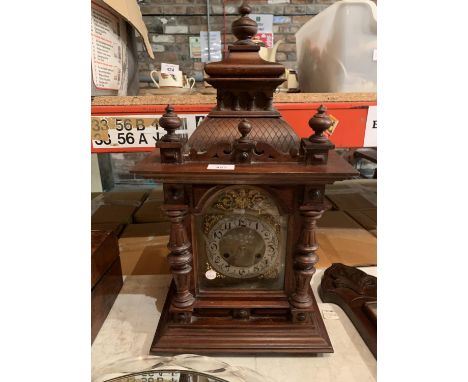 AN ORNATE WOODEN CLOCK 