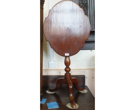 A Victorian Mahogany shaped top snap top table on turned column and tripod support