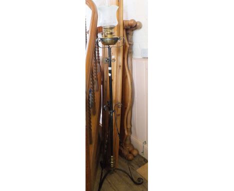 A wrought iron and Brass bowl standard oil lamp and a Victorian Mahogany curtain pole with rings