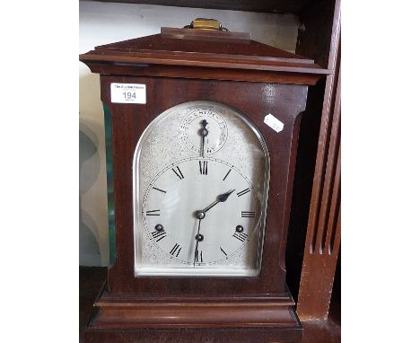 Edwardian mahogany table clock, silver dial, German movement striking on gongs, 18" tall