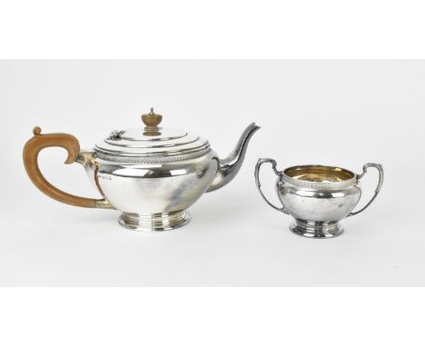 A mid 20th century English silver teapot, Birmingham 1947, makers initials J.W.C(or L?)&amp;S, of bulbous form with wooden ha