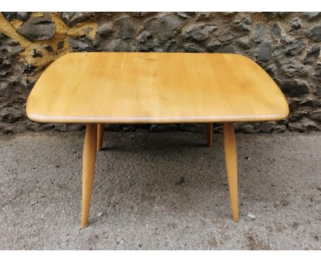 A small blonde elm Ercol design side table, of rectangular form with four turned legs, 69 cm wide x 43 cm high 