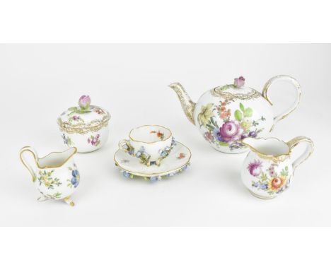 A late 19th century Meissen 'forget me not' encrusted teacup and saucer, both pieces six footed with hand painted flowers and