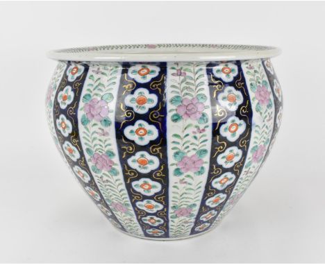 A Chinese late Qing dynasty porcelain jardiniere, with applied enamel flowers and trailing foliage, with underglaze blue and 