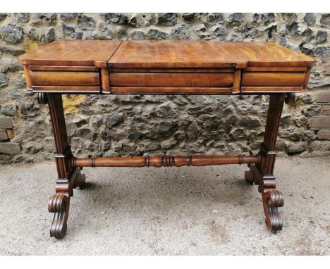 A Regency mahogany library games table with slide top revealing a backgammon board on tooled leather, above two small drawers