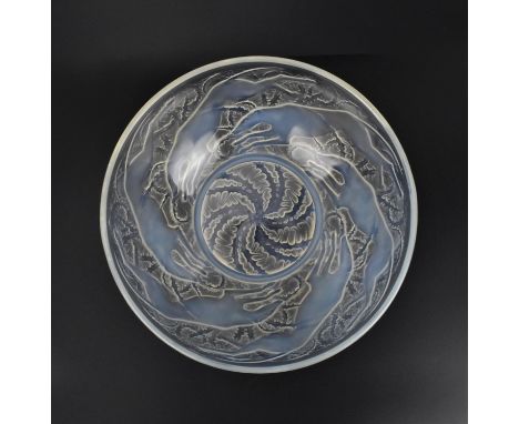 A René Lalique 1920s opalescent glass 'Chiens' pattern bowl, model number 3214, with moulded leaping dogs and foliage on a cl