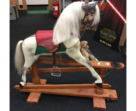 A Wooden Rocking Horse: dapple grey with white mane and tail, open mouth with teeth, wooden rocker base with plaque 'Haddon R