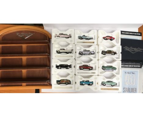 12 x Franklin Mint The Classic Cars of The Fifties 1/43 scale diecast models, together with wooden display stand and related 