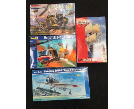 Four plastic model kits: Monogram 1/24 scale Huey Gunship (sealed); Revell 1/24 scale #4905 Bell UH-1 Huey; Trumpeter #2410 1