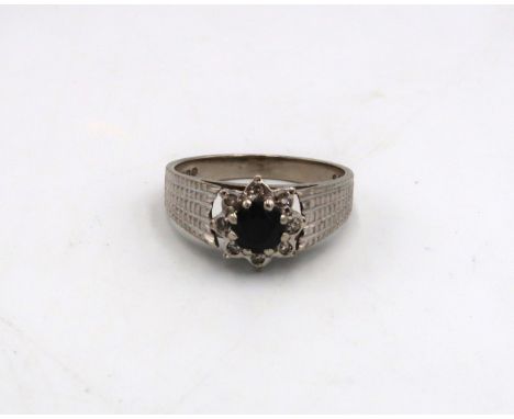 A 9ct white gold dress ring - sapphire to shoulder with eight small diamonds - approx weight 3.6 grams - ring size N/O - ligh