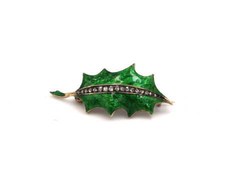 A holly leaf shaped with green enamel ground with a central spine set with seventeen part cut 'chip' diamonds in sunken claw 