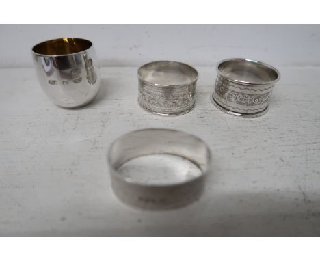 Three silver napkin rings and a silver gilt egg cup - approx total weight 2.8 troy oz 