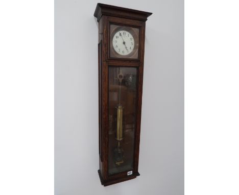 An oak cased Synchro Nome master clock with Arabic numerals to white enamel dial (Case in good condition, glass intact). 92cm
