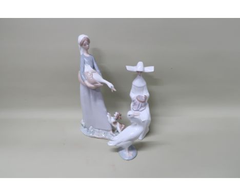 A Lladro girl and goose and dog figurine No 4866, a Lladro Nun sitting sewing embroidery No 5501 and a Lladro little duck fig