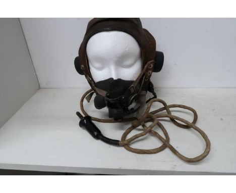 A Lancaster flying helmet with its mask and intercom cable - in worn but reasonable condition - used in a Lancaster bomber 
