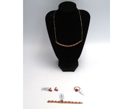 A set of 9ct gold oval ruby, zircon and diamond jewellery to include a necklace, bracelet, earrings and a ring. Size M. Total