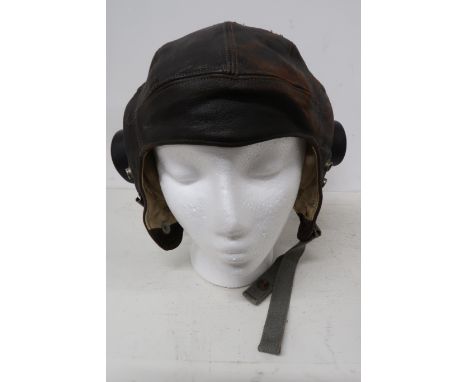 A Lancaster flying helmet with headphones, intercom cable and goggles - in worn but reasonable condition - used in a Lancaste