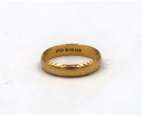 A 22ct hallmarked wedding band size K - approx weight 3 grams with ribbed edge decoration - light surface scratches 