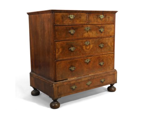 A Queen Anne feather banded walnut chest on stand, first quarter 18th century, with two short and three long graduated drawer