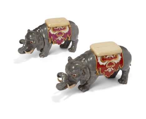 Two Meissen porcelain models of caparisoned elephants, 19th century, blue crossed swords marks, one with cut cancellation mar