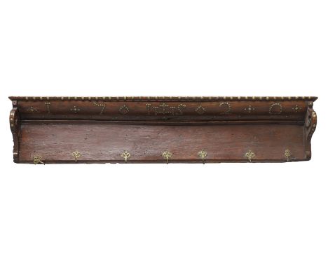An English walnut clothes rack, first quarter 18th century, decorated in brass studs with the date 1720 and with IHS monogram