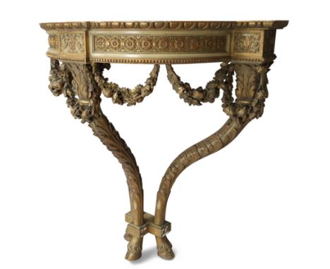 A French giltwood console table, first quarter 19th century, with carved frieze above carved floral swags, on three legs, car