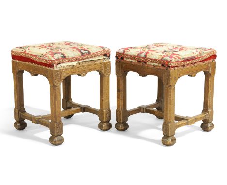 A pair of George IV oak Gothic revival stools, first quarter 19th century, with needlework tapestry seats, on chamfered legs 
