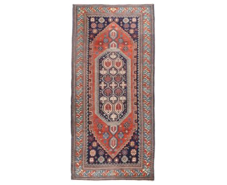 A Caucasian Shirvan rug retailed by Waring & Gillow, first quarter 20th century, the central field with lozenge medallion and