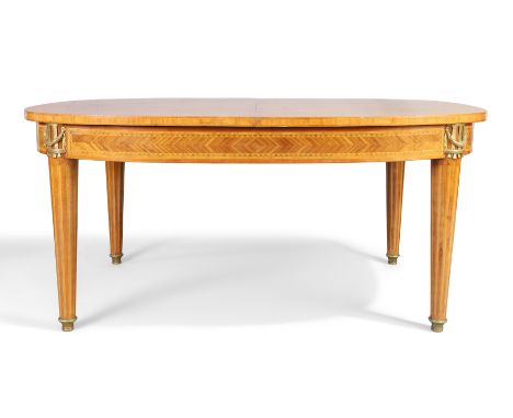 A French inlaid and gilt-brass mounted kingwood dining table, first quarter 20th century, on cylindrical tapering legs to gil