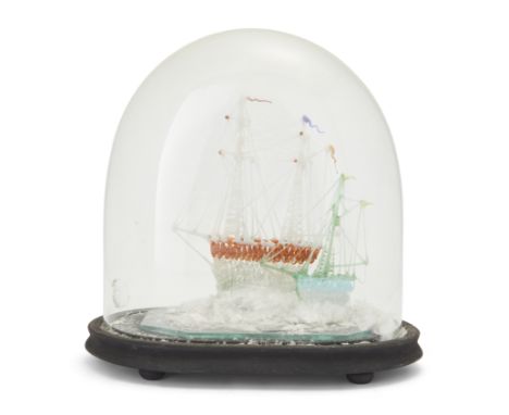 A Victorian Nailsea type coloured glass model of two friggers, under a glass dome with later stained wood oval base, approx. 