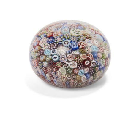 A Baccarat close-packed millefiori glass paperweight, dated 1848, the tight arrangement of assorted brightly coloured canes i