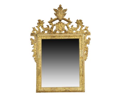 A large Italian giltwood wall mirror, 17th / 18th century, the carved Venetian rectangular frame with later C-scroll surmount