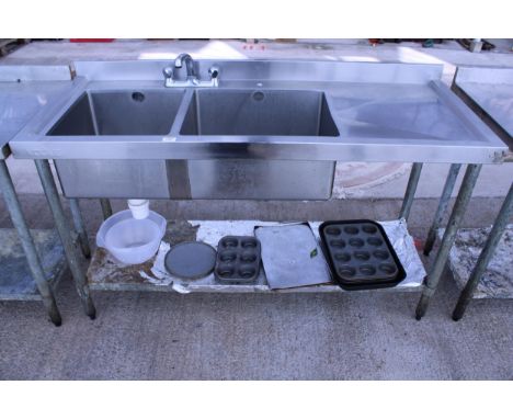 A STAINLESS STEEL DOUBLE SINK UNIT WITH LOWER SHELF