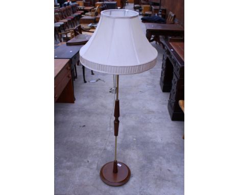 A 1970'S TEAK AND BRASS STANDARD LAMP WITH SHADE